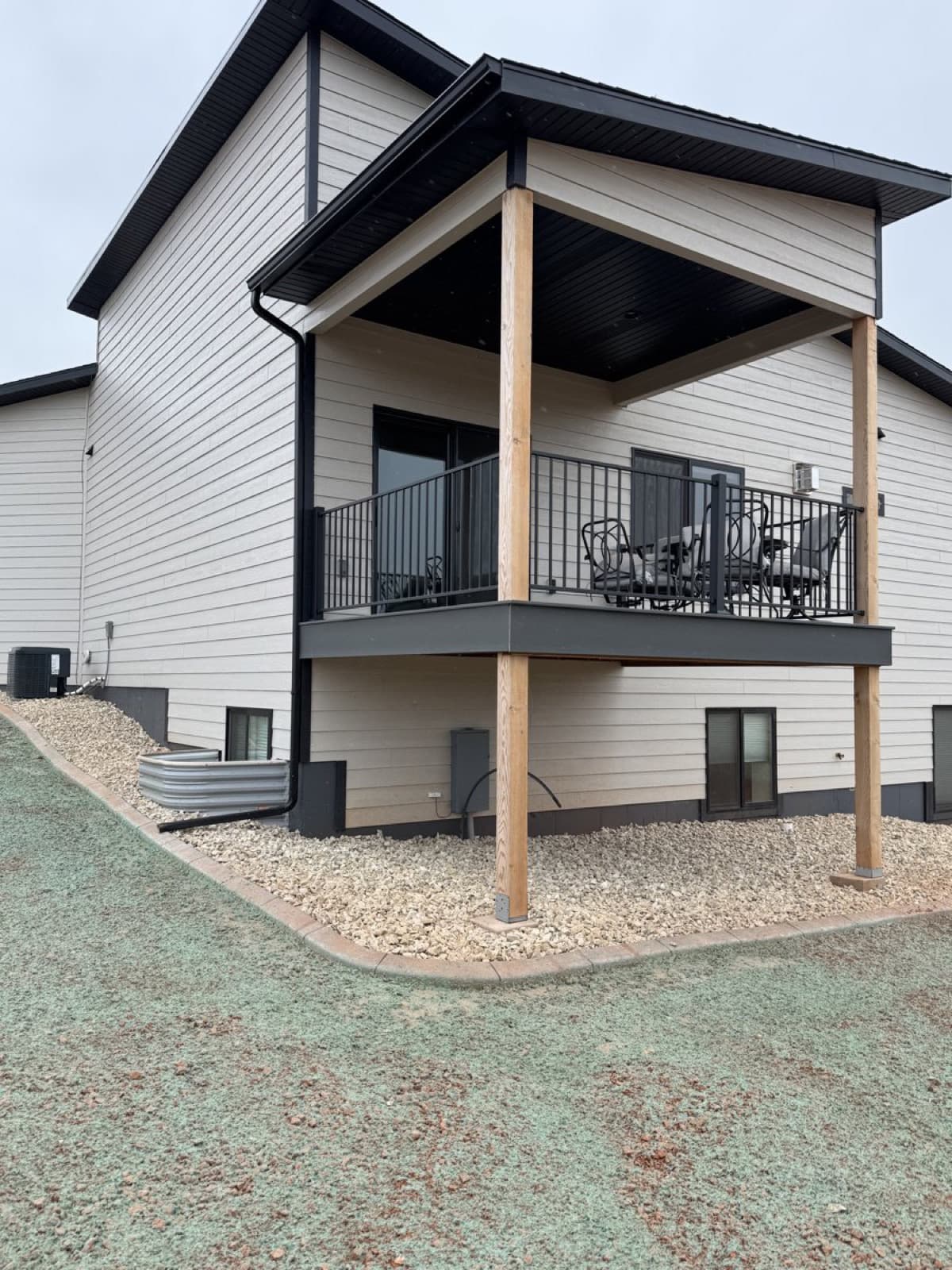 Completed landscape with rock beds, grading, and plantings at new construction home