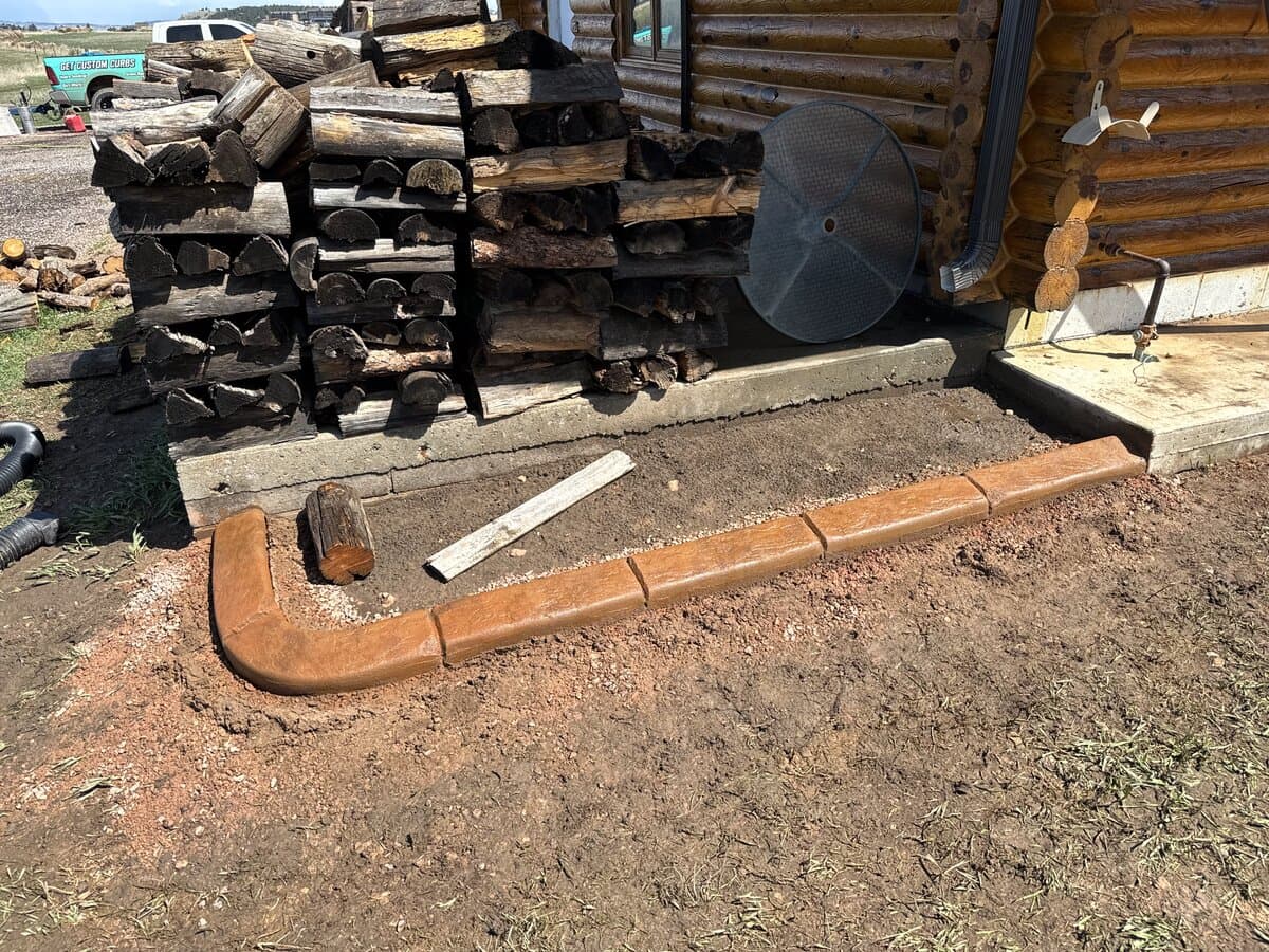 Log cabin property before curbing installation