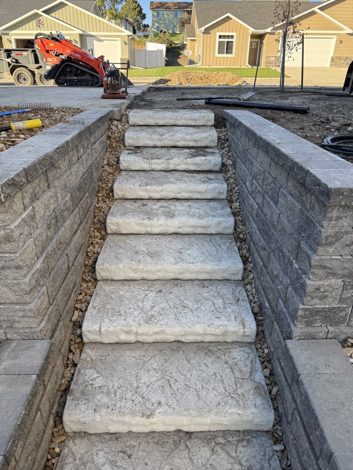 Stone step installation connecting different levels of a residential yard