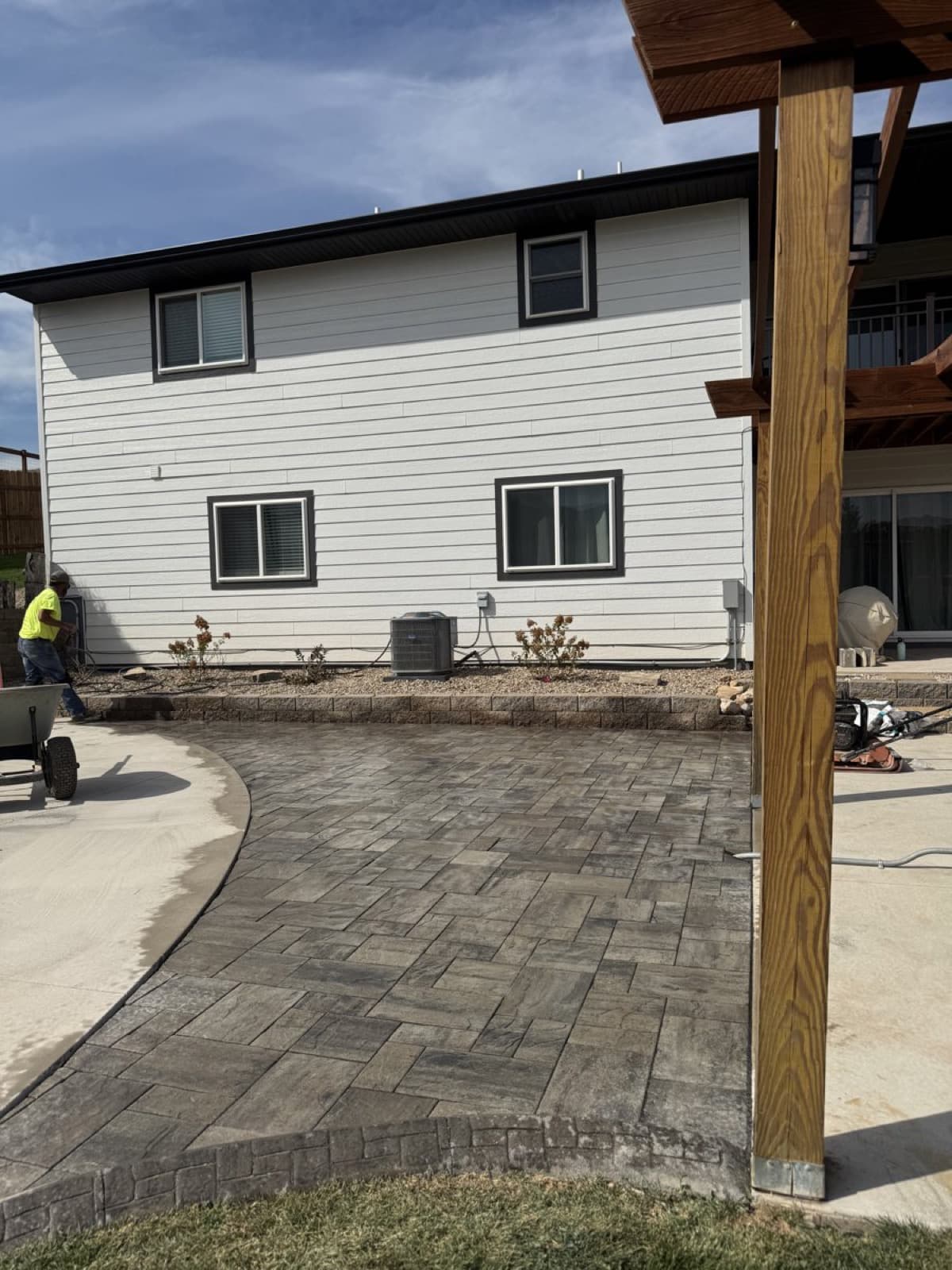 Paver walkway leading to a backyard entertaining area