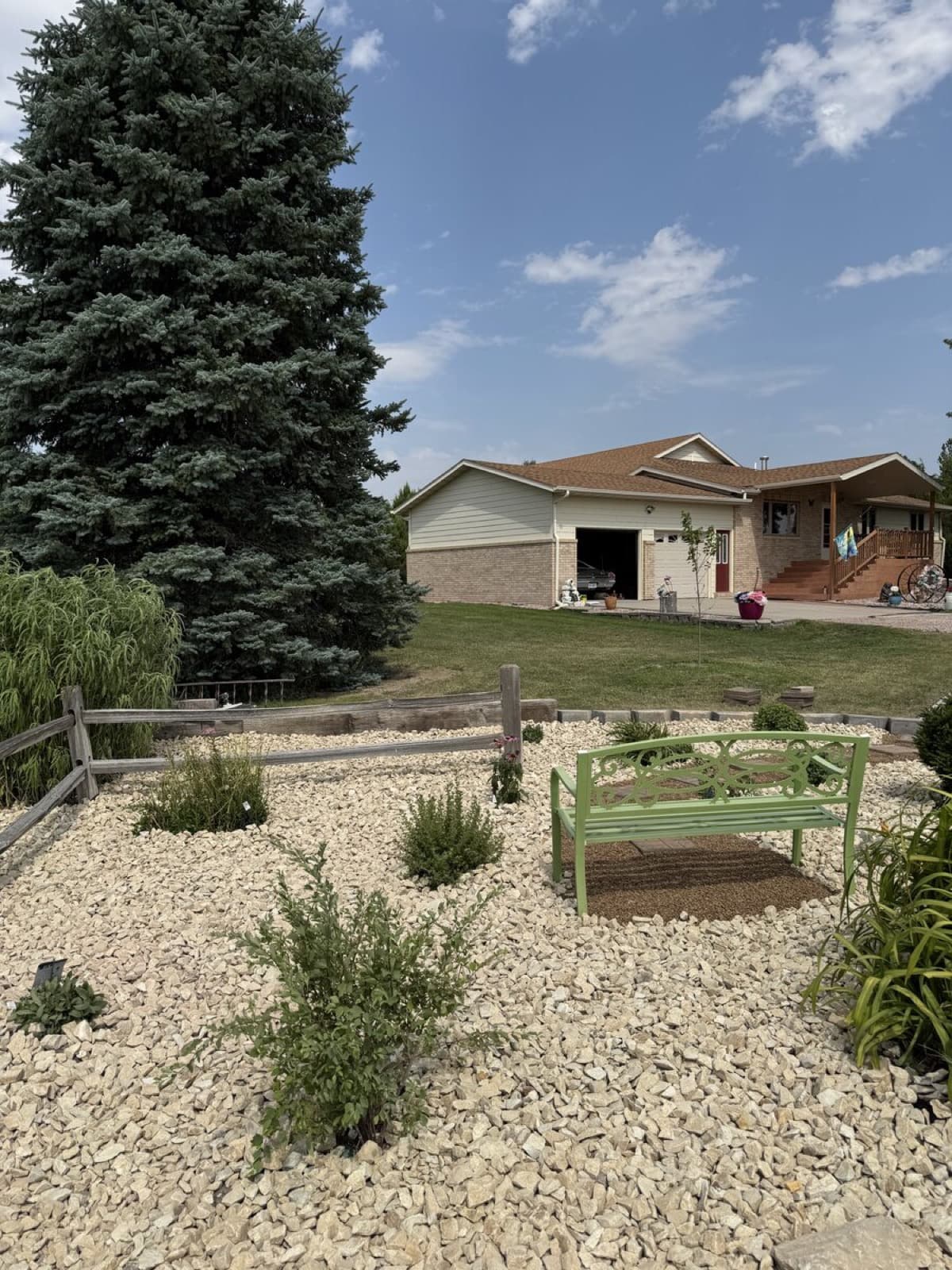 Large rural property landscape with rock beds and native plantings in the Black Hills