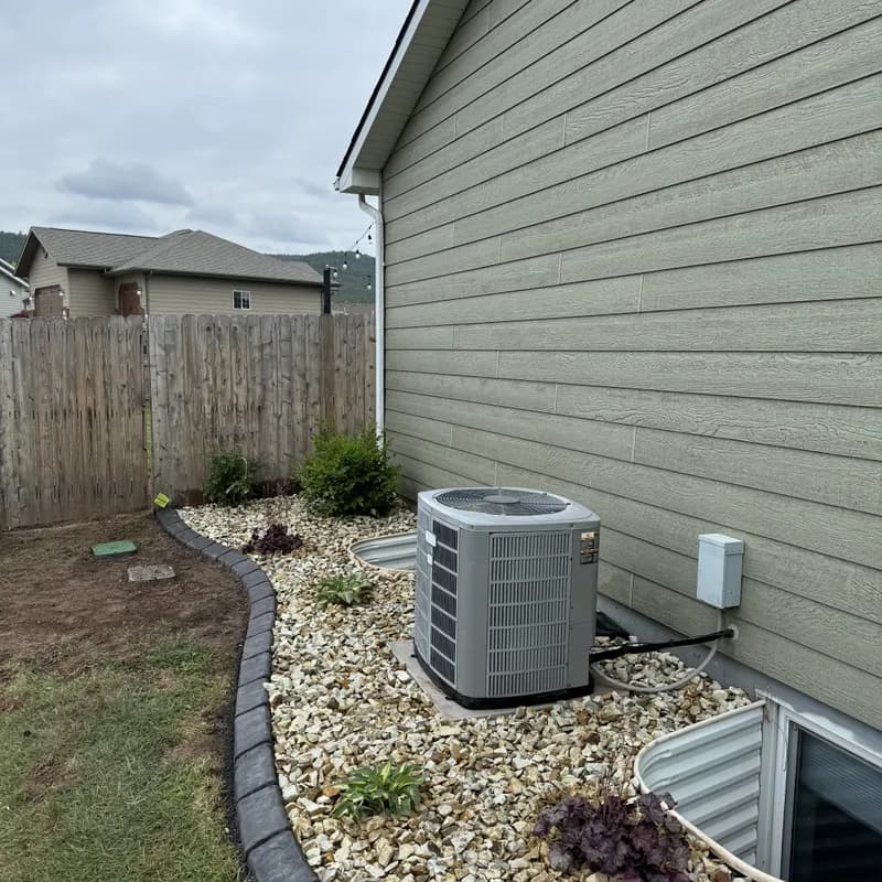 Backyard landscaping with curbing and plantings in the Black Hills by ATK Landscaping