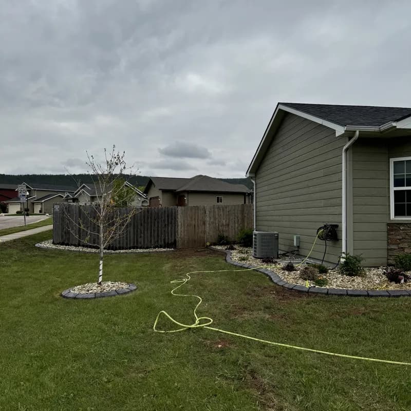 Completed ATK Landscaping project featuring curbing, patio, and plantings