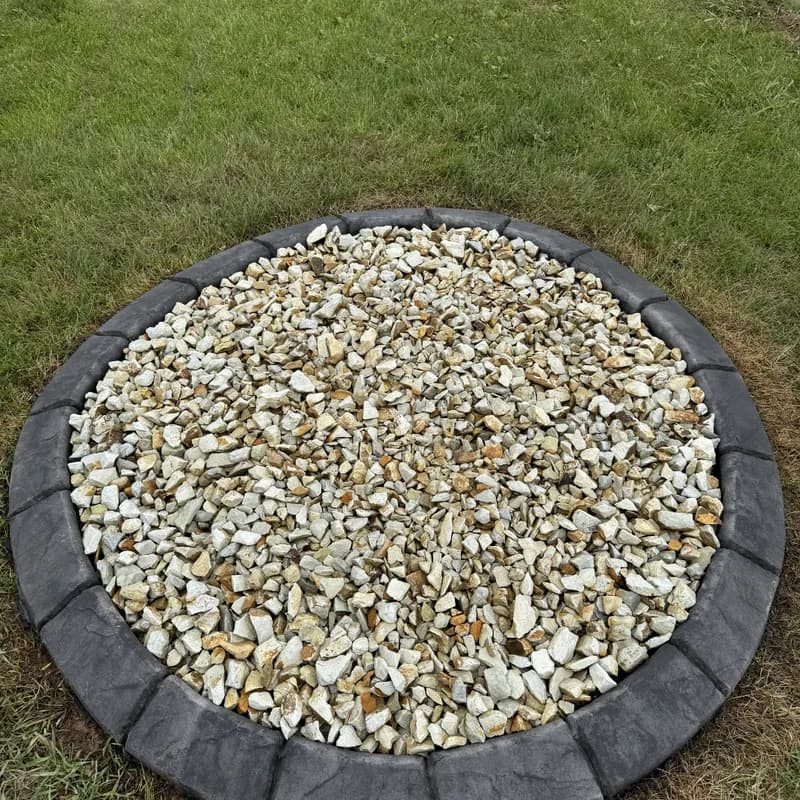 Round rock bed with concrete landscape curbing by ATK Landscaping in Rapid City, SD