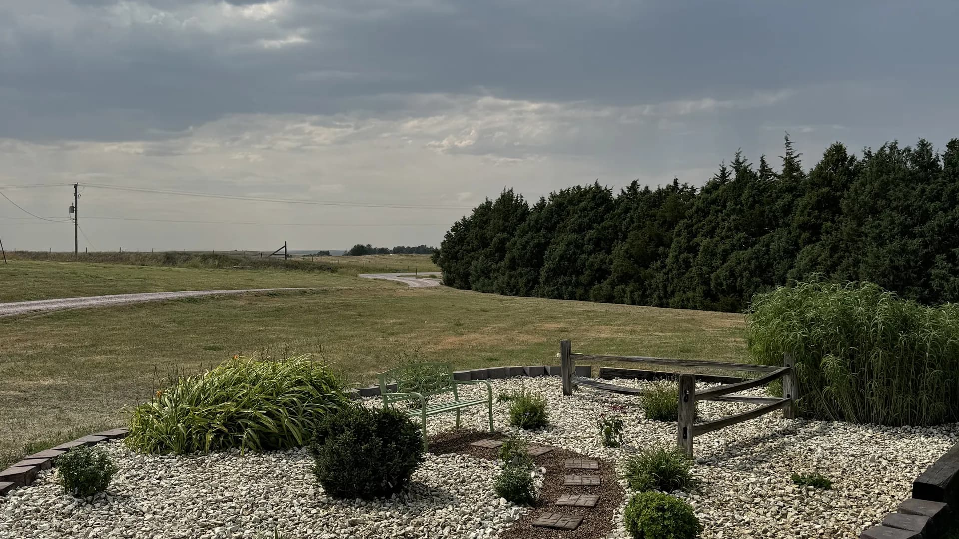 Complete landscape bed installation with curbing, rock, and plantings by ATK Landscaping