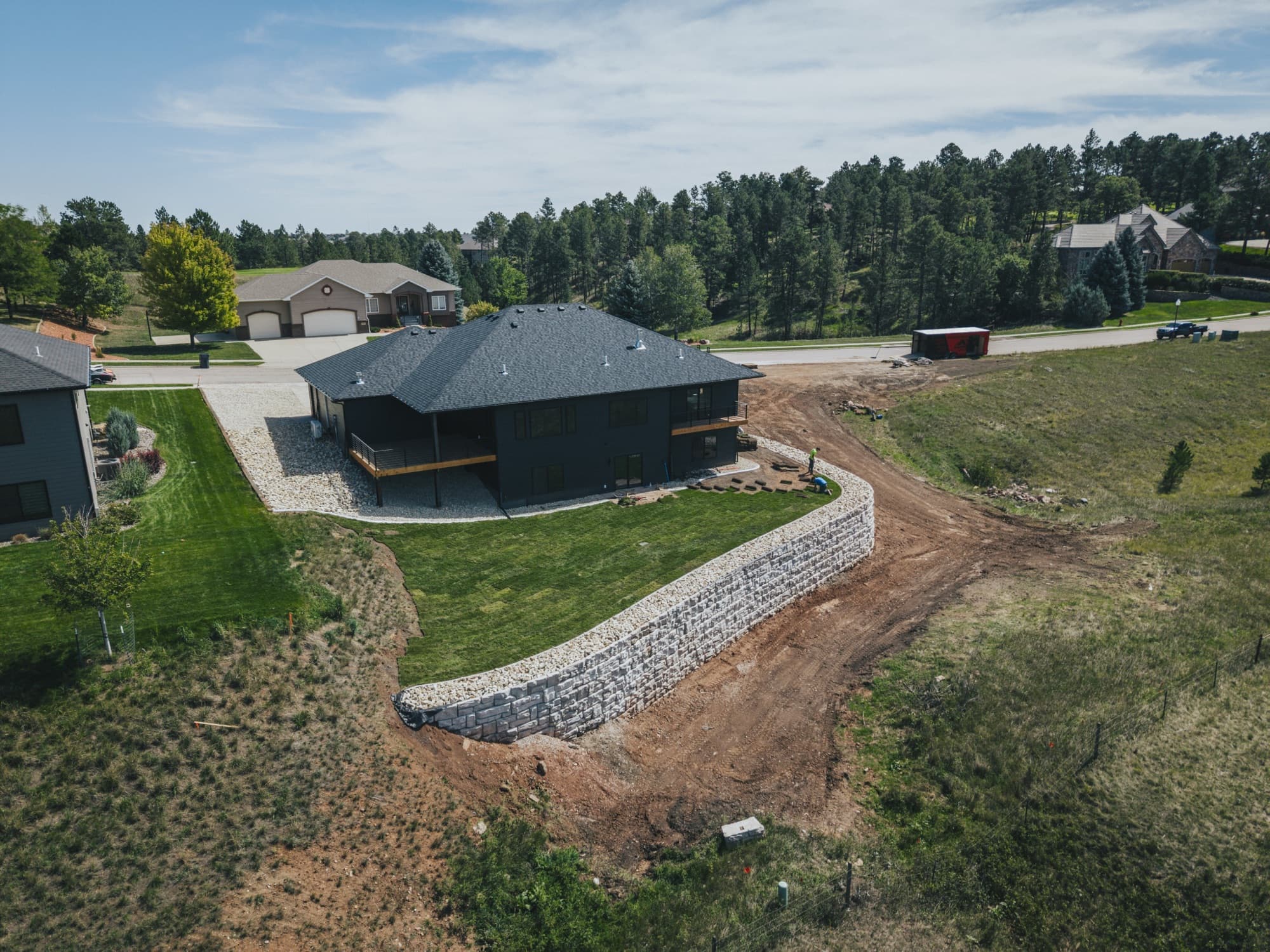 Aerial view of a curved retaining wall around a sloping yard